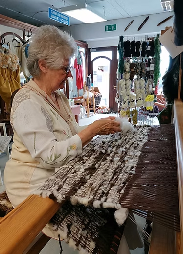 Sandra King working on a wool carpet.